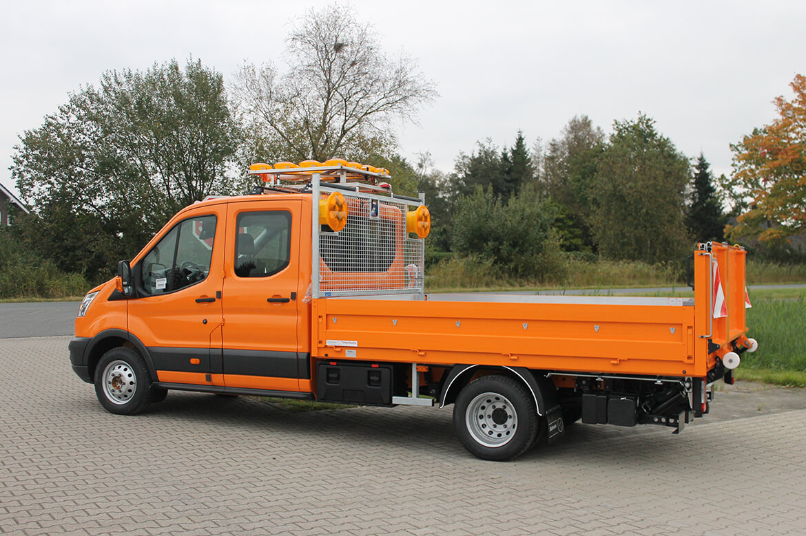 Ford Transit mit faltbarer Ladebordwand für Pritschen, Blinkpfeilanlage, Stirnwandgitter, Blitzleuchten, Kunststoffboxen